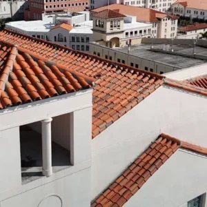 Close-up of a completed section of the clay tile roof after professional cleaning and maintenance at Hotel Colonnade.