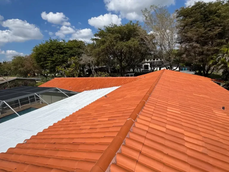 Shot highlighting the professional restoration of a flat roof section integrated with the barrel tile system in Pinecrest.